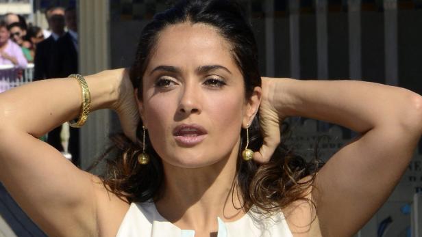 EPAepa03389828 Mexican actress Salma Hayek poses for photographers at the unveiling of a beach changing-booth in her name, along the Deauville beach front, during the 38th Deauville American Film Festival, in Deauville, France, 08 September 2012. The fest