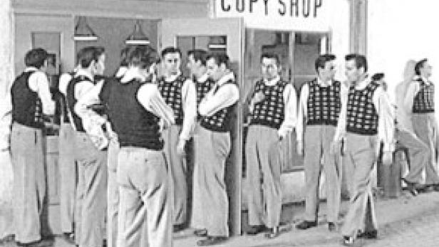 Eine Gruppe von Männern steht vor einem Copy Shop.