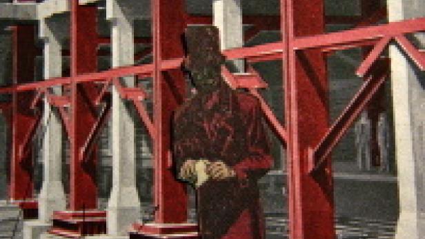 Eine stilisierte Figur mit Zylinder steht vor einem Gerüst aus roten Stahlträgern.