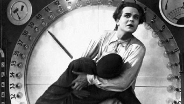 Eine Szene aus dem Film „Sicherheit geht vor!“, in der Harold Lloyd an einer großen Uhr hängt.