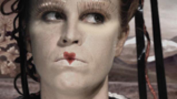 Eine Frau mit starkem Make-up und einem roten Herz auf den Lippen blickt zur Seite.