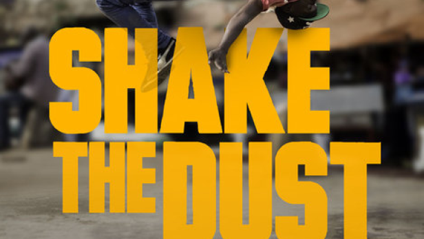 Ein Mann macht einen Handstand vor dem Schriftzug „Shake the Dust“ auf einem Filmplakat.