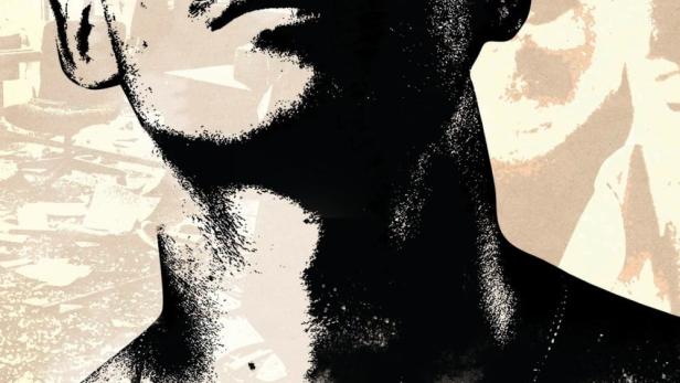 Ein Schwarz-Weiß-Porträt eines Mannes mit einer Kette, im Hintergrund ein weiteres Gesicht.