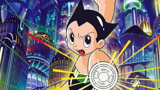 Astro Boy steht vor einer futuristischen Stadt und scheint seine Kräfte einzusetzen.