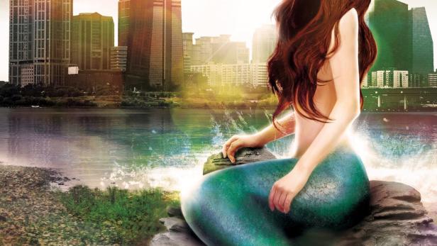 Eine Meerjungfrau sitzt vor der Skyline von Seoul, im Hintergrund ein Fluss.