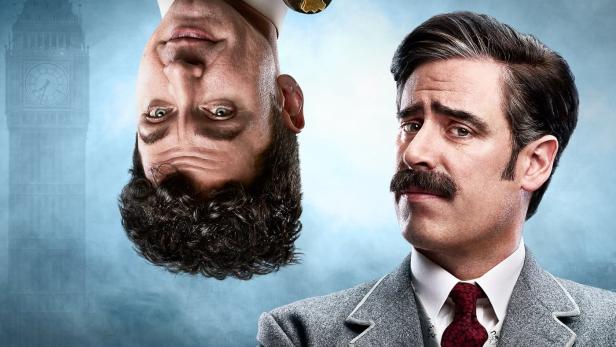 Das Filmplakat zu „Houdini & Doyle“ zeigt Houdini gefesselt und auf dem Kopf stehend über Doyle.