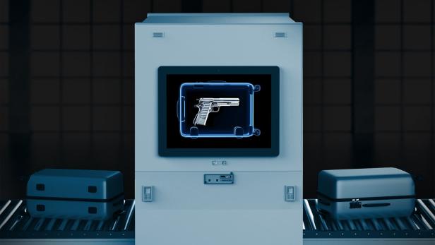 Das Röntgenbild einer Pistole in einem Koffer auf dem Bildschirm eines Flughafenscanners.