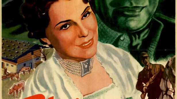 Das Filmplakat für „Die Alm an der Grenze“ zeigt eine Frau, einen Mann mit Hut und eine Berglandschaft.