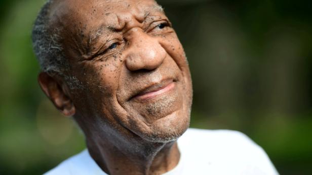 Bill Cosby looks on outside his house after Pennsylvania's highest court overturned his sexual assault conviction and ordered him released from prison immediately, in Elkins Park