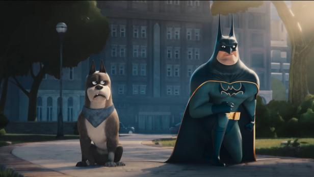 Ein animierter Batman steht neben einem mürrisch dreinblickenden Hund mit Halstuch.
