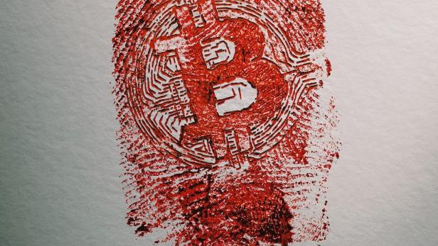 Ein blutiger Fingerabdruck in Form eines Bitcoin-Symbols.