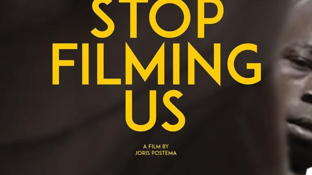 Das Filmplakat für „Stop Filming Us“ zeigt den Titel in gelber Schrift vor einem unscharfen Hintergrund.