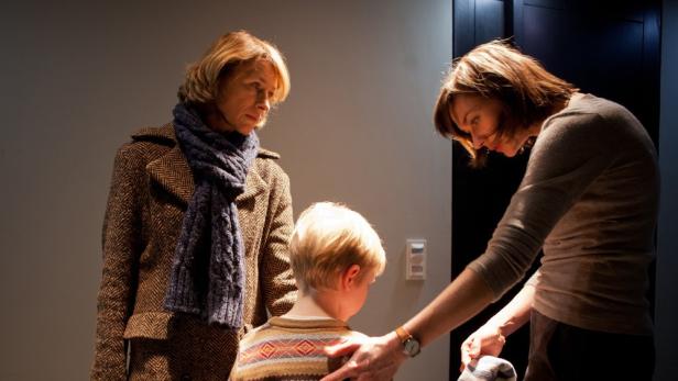 Zwei Frauen kümmern sich um ein Kind.