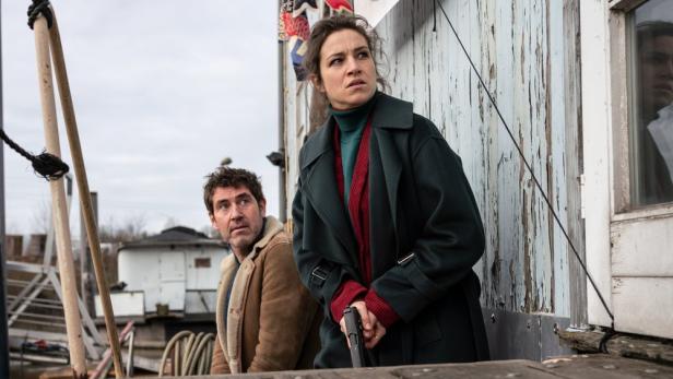 Katharina Tempel in einer Szene aus „Was wir verbergen“ mit einer Waffe in der Hand.