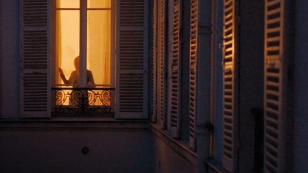 Das Filmplakat für „Jackie the Wolf“ zeigt eine Person, die in einem erleuchteten Fenster steht.