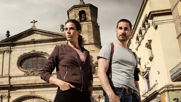 Zwei Kommissare stehen vor einer Kirche in Barcelona.