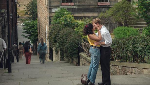 Ein Mann und eine Frau küssen sich auf Stufen in Edinburgh