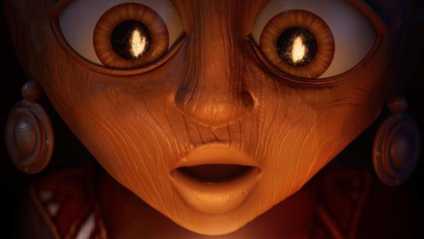 Ein hölzernes Gesicht mit großen Augen und einem überraschten Ausdruck hält ein leuchtendes Objekt in den Händen.