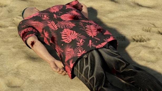 Ein Mann mit einer Schusswunde liegt am Strand.