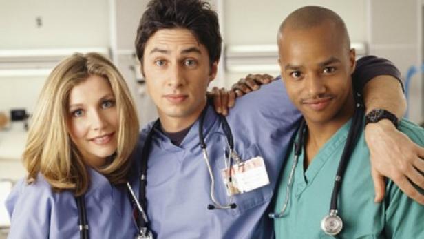 Drei Ärzt:innen in Uniform lächeln in die Kamera.