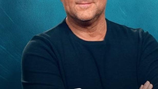 Ein Porträt von Martin Rütter vor dem Cover seiner Sendung „Mein tierisches Jahr“.