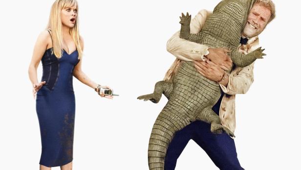 Ein Mann umarmt einen Alligator, während eine Frau entsetzt daneben steht.