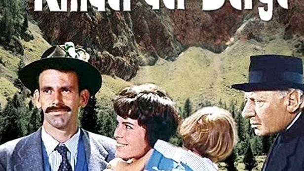 Das Filmplakat für „Kinder der Berge“ mit Maximilian Schell, Heinrich Gretler und Alfred Rasser vor einer Bergkulisse.