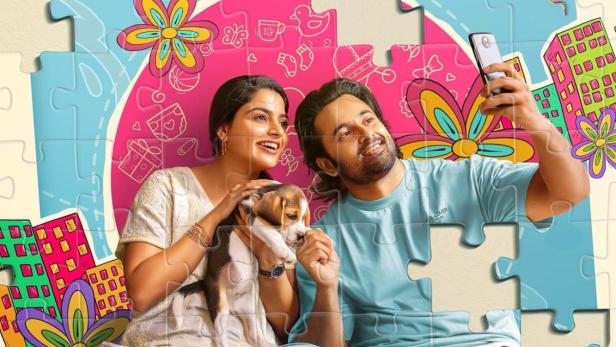 Ein Paar macht ein Selfie mit einem Beagle-Welpen vor einem Puzzle-Hintergrund mit dem Titel „Get-Set Baby!“.