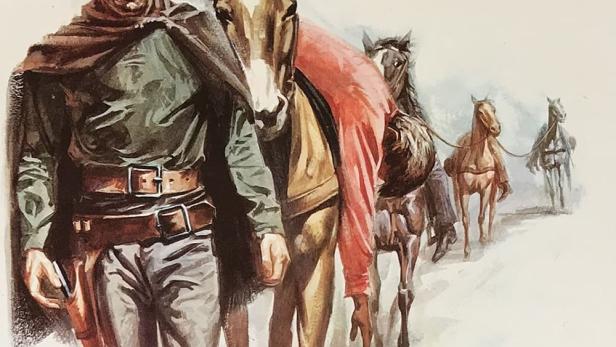 Ein Cowboy mit Hut und Poncho führt eine Reihe von Pferden an.