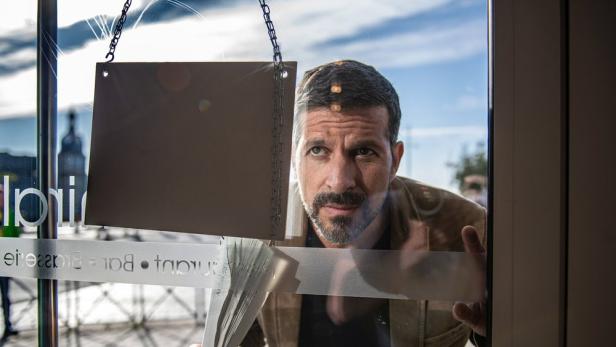 Kommissar Dupin blickt durch das Fenster eines Restaurants.