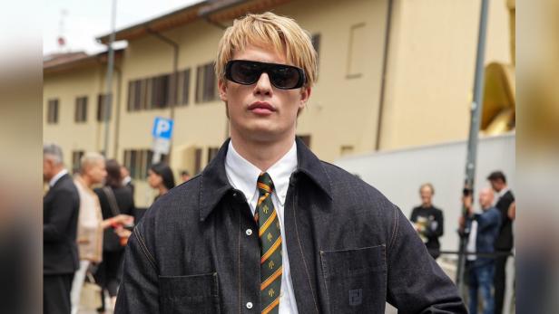 Nicholas Galitzine trägt eine dunkle Jacke, ein Hemd und eine Krawatte.