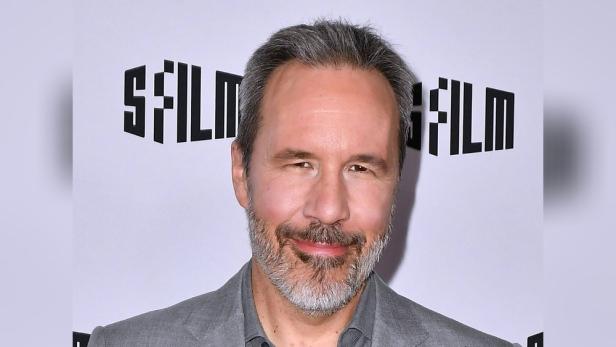 Porträt von Regisseur Denis Villeneuve vor einem SFFILM-Hintergrund.