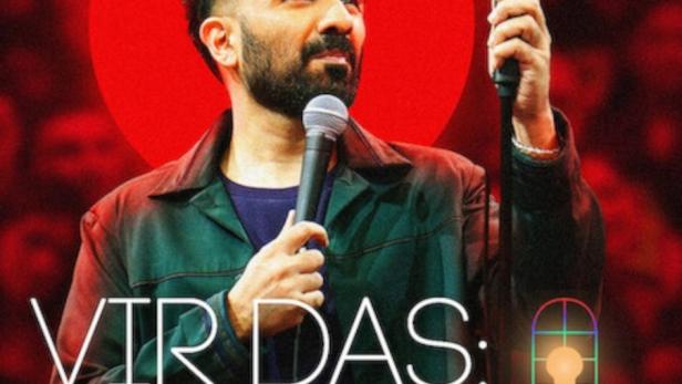 Der Comedian Vir Das hält ein Mikrofon und eine Lampe in der Hand.