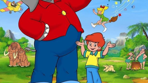 Eine bunte Szene mit Benjamin Blümchen, einem Jungen, einer Hexe und einem Heißluftballon.