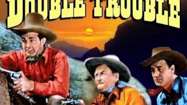Drei Cowboys zielen mit ihren Revolvern auf dem Filmplakat von „Trailing Double Trouble“.