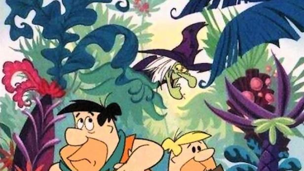Fred Feuerstein und Barney Geröllheimer in „The New Fred and Barney Show“, mit einer Hexe im Hintergrund.