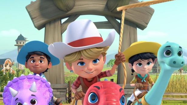 Das Logo der „Dino Ranch“ mit den drei jungen Reitern und ihren Dinosaurier-Freunden.