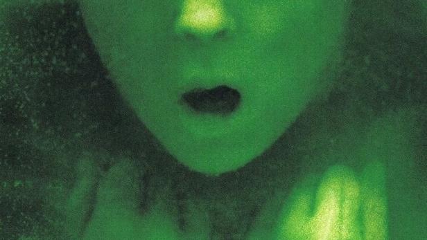 Das grünliche Gesicht eines Kindes mit dem Titel „Geister“ im Vordergrund.