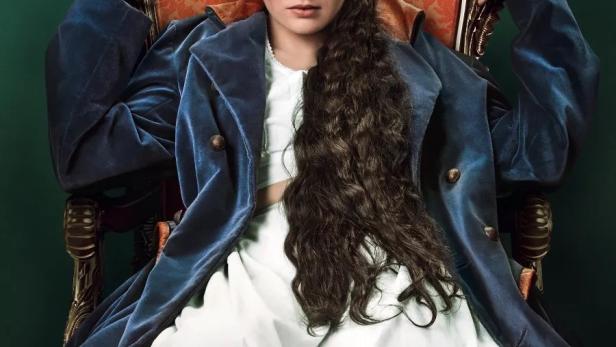 Das Filmplakat für „Die Kaiserin“ zeigt eine junge Frau in einem blauen Mantel, die auf einem goldenen Thron sitzt.