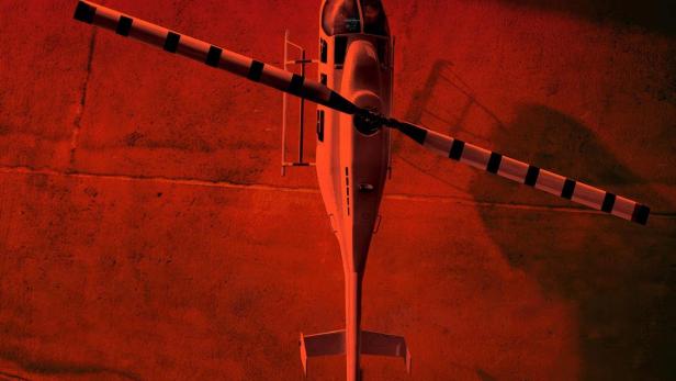 Ein Hubschrauber steht vor einem Gebäude, im Vordergrund der Titel „Der Helicopter Coup“.
