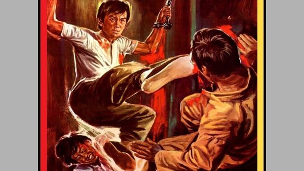Ein Mann mit Handschellen tritt einen anderen Mann auf dem Cover von „In der Gewalt der gelben Katzen“.