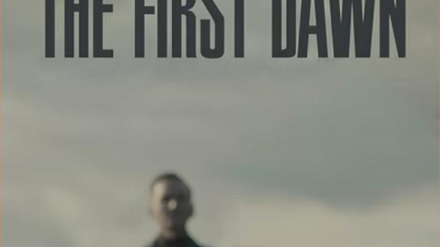 Das Filmplakat für „The First Dawn“ zeigt Personen vor einem trüben Himmel.