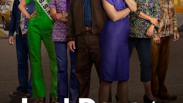 Das Ensemble der Besetzung von „Last Days of the Space Age“ steht vor einem Vorstadthaus.