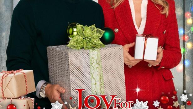 Ein Mann und eine Frau halten Geschenke vor dem Hintergrund des Films „Joy for Christmas“.