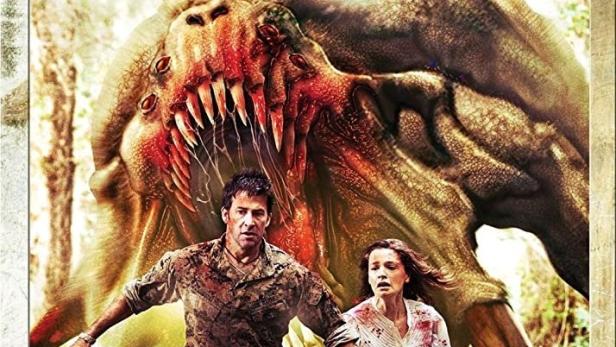 Ein Mann und eine Frau fliehen vor einem riesigen Monster auf dem Filmplakat zu „Ferocious Planet“.