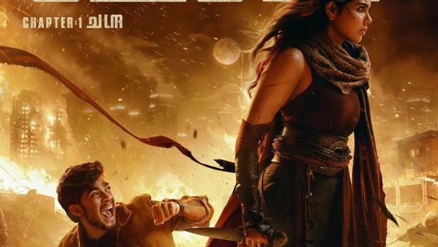 Eine Frau mit einem Schwert steht vor einer zerstörten Stadt, während ein Mann im Vordergrund schreit.