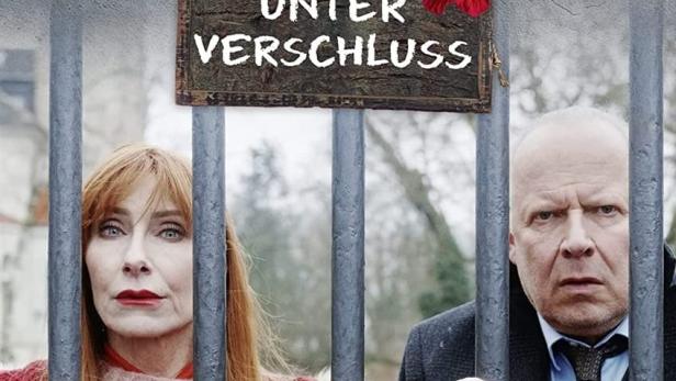 Das Filmplakat zu „Familie Bundschuh – Unter Verschluss“ mit Andrea Sawatzki und Axel Milberg hinter Gittern.
