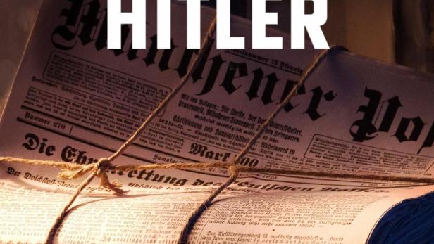 Ein Stapel alter Zeitungen mit der Schlagzeile „Schlagzeilen gegen Hitler“.