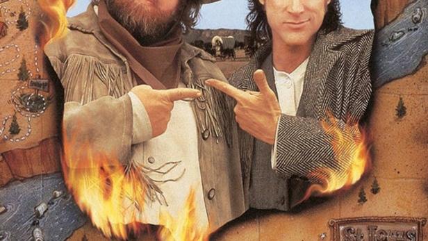 Zwei Männer im Western-Stil ragen aus einem brennenden Loch in einer Karte.