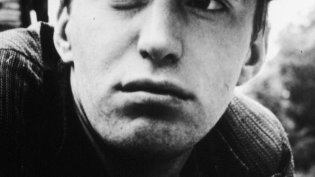 Ein Schwarzweißporträt eines jungen Mannes mit Schirmmütze vor dem Filmtitel „Kvarteret Korpen“.